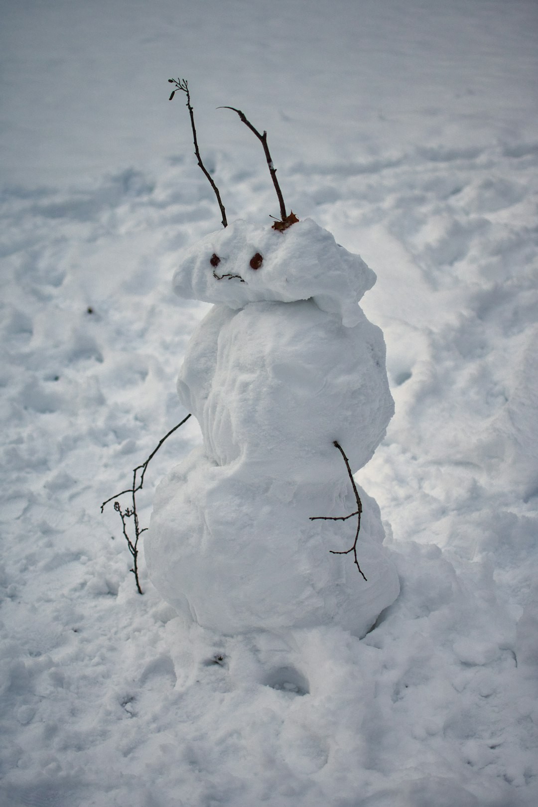 white snowman on snow covered ground